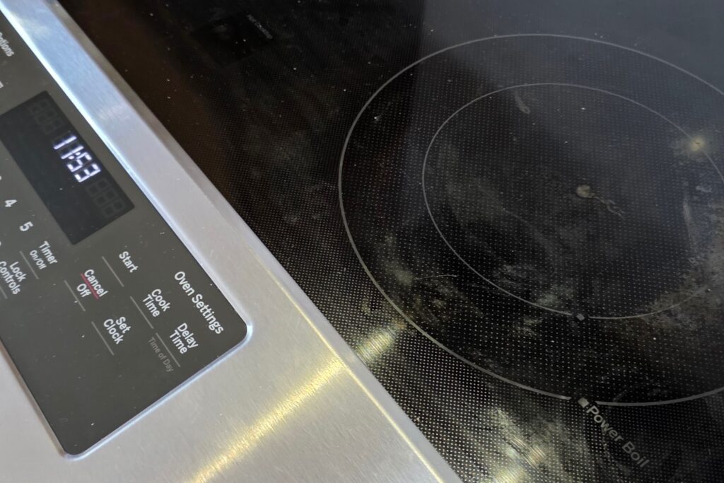 Stovetop with light buildup before cleaning